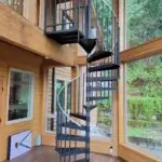 econo steel spiral staircase with open end treads in a wood paneled sunroom