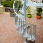 galvanized steel spiral staircase going up to rooftop deck